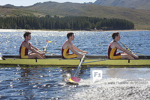 Men's rowing boat in water