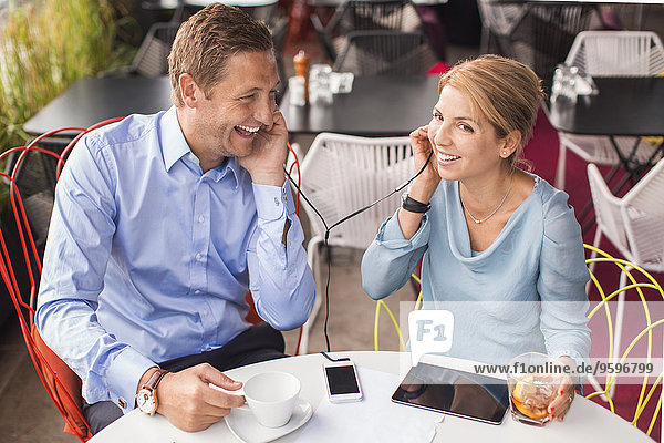 Happy business people taking break in cafe