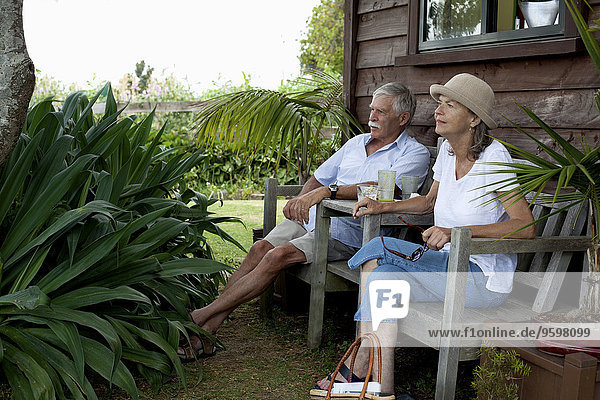 Senior couple relaxing by wooden cabin  Raglan  New Zealand