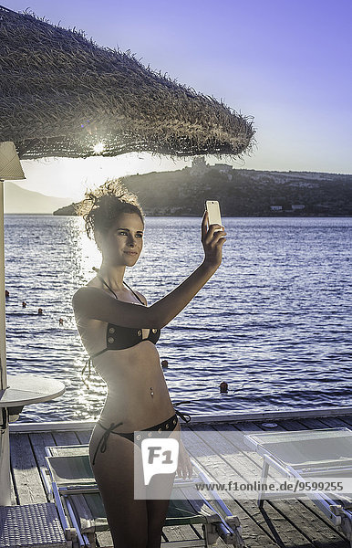Junge Frau nimmt Selfie in Urlaub