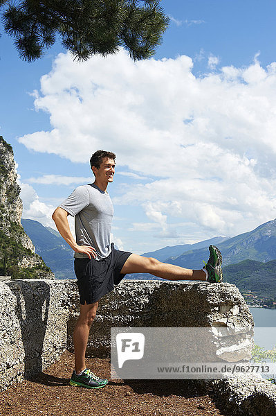 Italy  Trentino  jogger stretching at Lake Garda