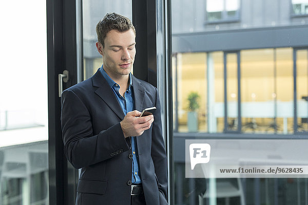 Businessman using smartphone in an office