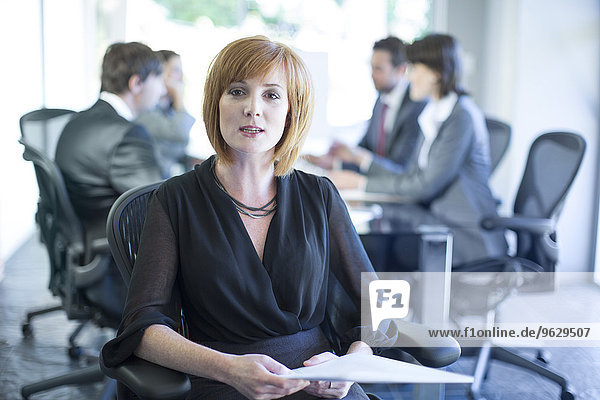 Businesswoman with meeting in the background