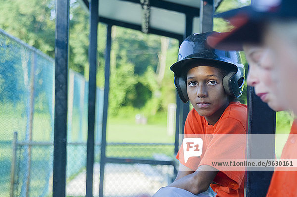 Young male baseball players waiting to play