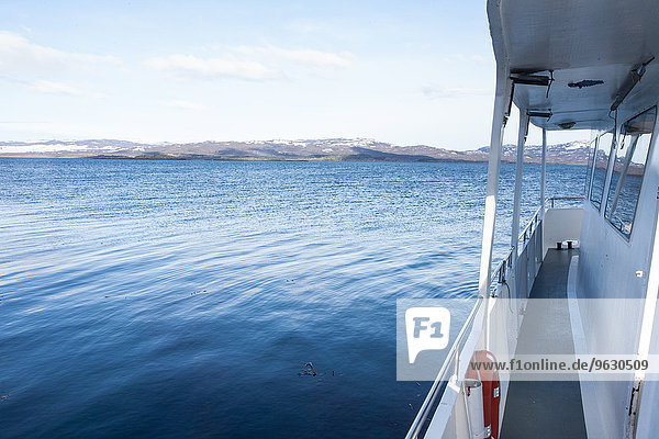 Side view of boat sailing toward coast  Ushuaia  Tierra del Fuego  Argentina