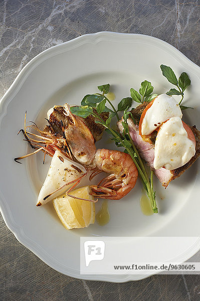 Plate with seafood  herb garnish and lemon slice