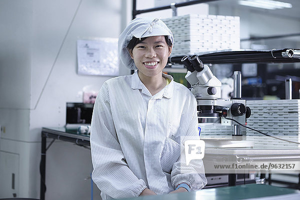 Portrait of worker in factory that specialises in creating functional circuits on flexible surfaces