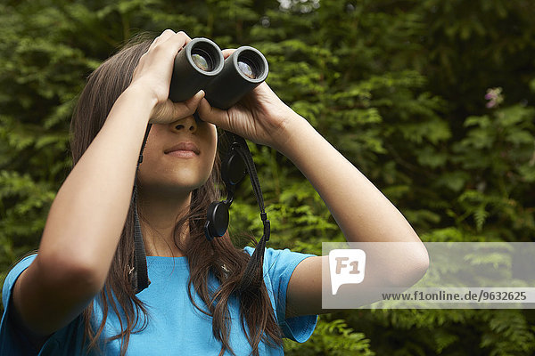 A young girl with bird watching binoculars.