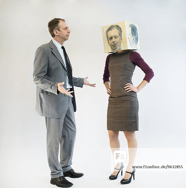 Businessman arguing with businesswoman wearing mask