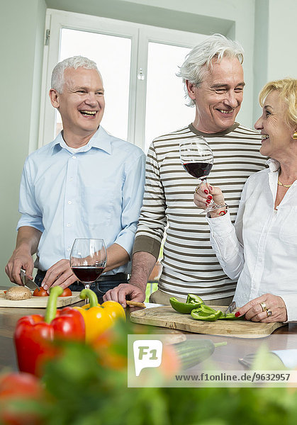 Senior men woman kitchen preparing dinner talking