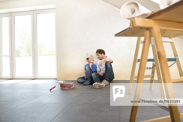 Father son working taking a break painting
