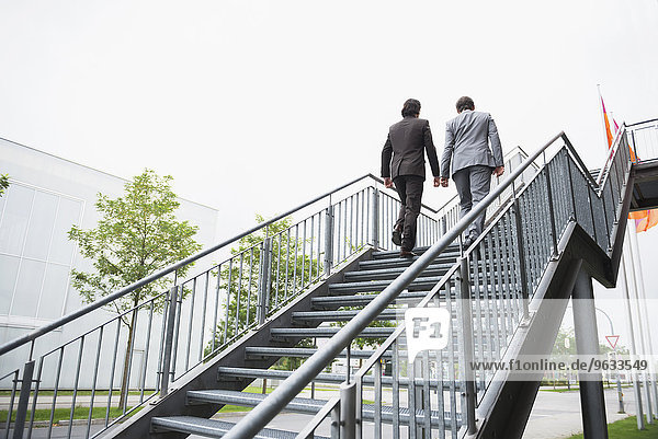 Businessmen ascent ladder of success job Teamwork