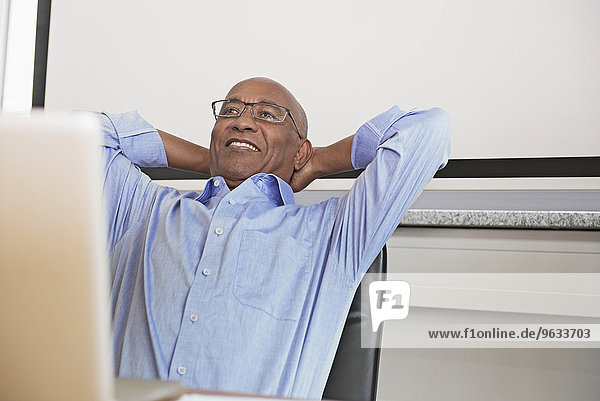 Businessman computer office smiling happy relaxed