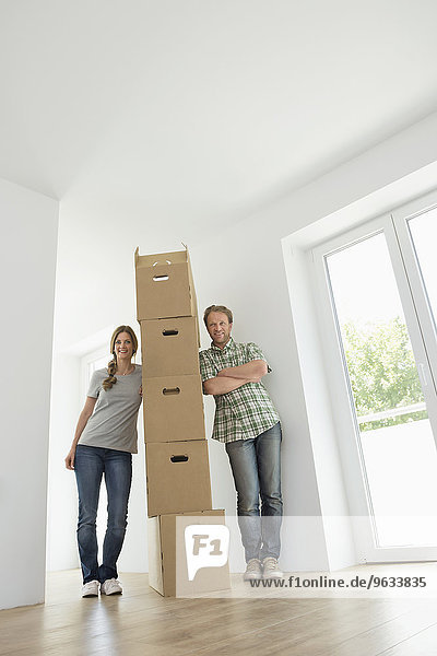 Man woman pile stack boxes new home