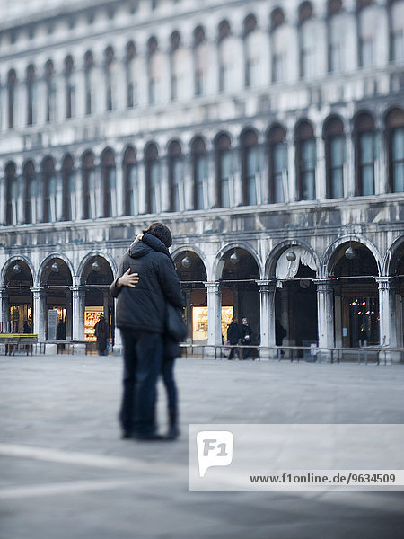 Piazza San Marco  St Mark's square. A couple embracing in the square.