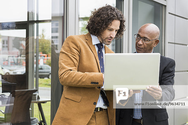 Two businessmen laptop computer suit meeting