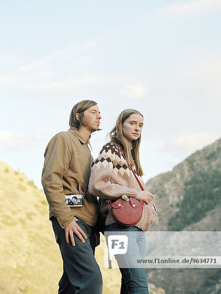 Young couple standing in a canyon.