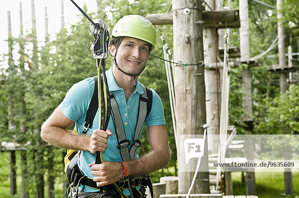 Portrait of young man climbing crag  smiling