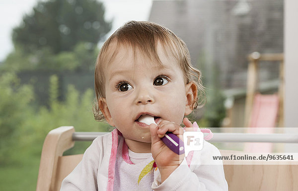 Baby girl 1 year old portrait spoon mouth
