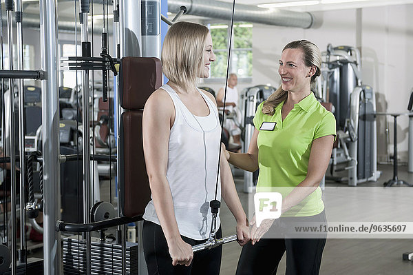 Woman fitness studio trainer sport assistance