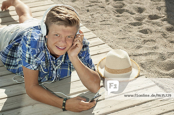 Boy beach summer headphones listening music