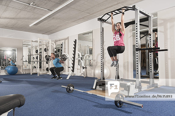 Man woman fitness centre training equipment
