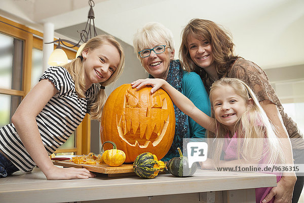 Family preparing pumpkin for Halloween