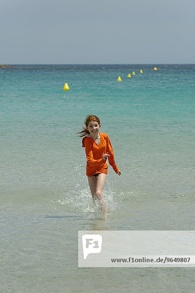 Girl running through the turquoise waters of the Bay of Rondinara  southeast coast  Corsica  France  Europe