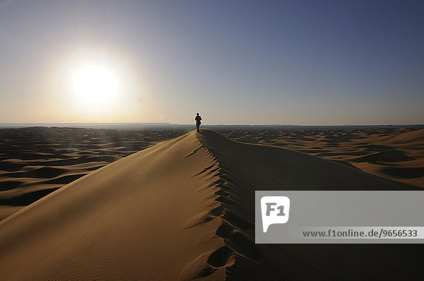 Tourist in the sand dunes of the Sahara  Merzouga  Morocco  Africa