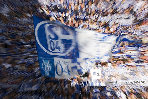 Football fans of German Bundesliga Club Schalke 04 waving giant flags  Gelsenkirchen  North Rhine-Westphalia  Germany  Europe