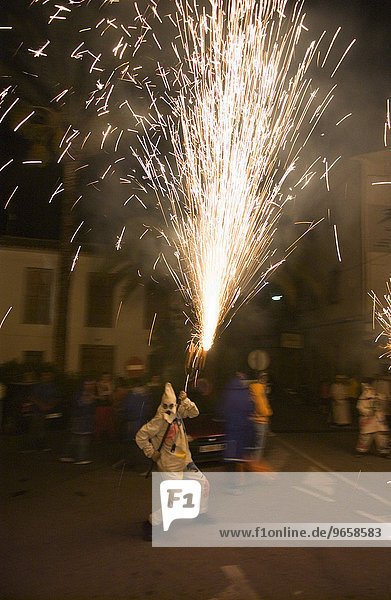 During the Correfoc or fire run  hooded Fire Devils run through the streets of Spanish towns brandishing fireworks  Altea  Costa Blanca  Spain  Europe