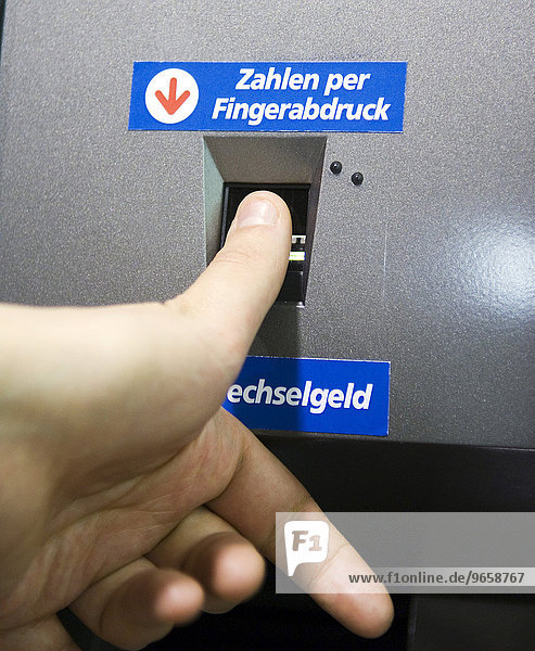 Using a fingerprint to pay at the automatic cashier in the real  - Future Store  part of the Metro Group  in Toenisvorst near Krefeld  North Rhine-Westphalia  Germany  Europe