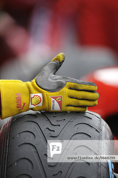 Hand eines Ferrari Mechanikers auf dem Reifen eines Boliden gibt dem Fahrer Signal Formel 1 Saison 2011 Großer Preis von Belgien Spa-Francorchamps Belgien Europa