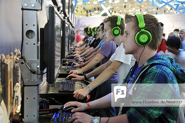 Young people playing computer games at the Gamescom Computer Game Fair  Cologne  North Rhine-Westphalia  Germany  Europe