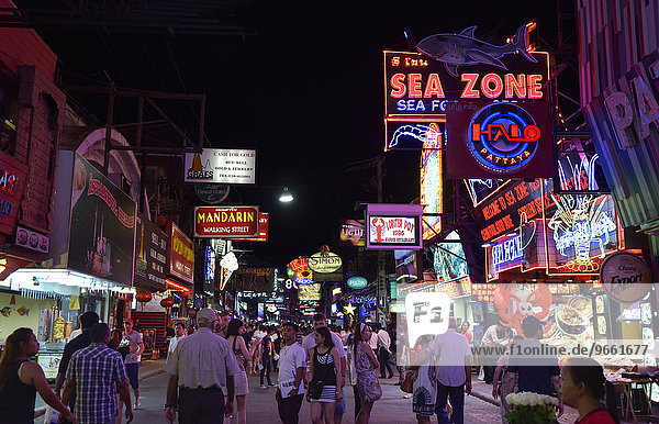Pedestrians and neon signs in Walking Street  Pattaya  Thailand  Asia