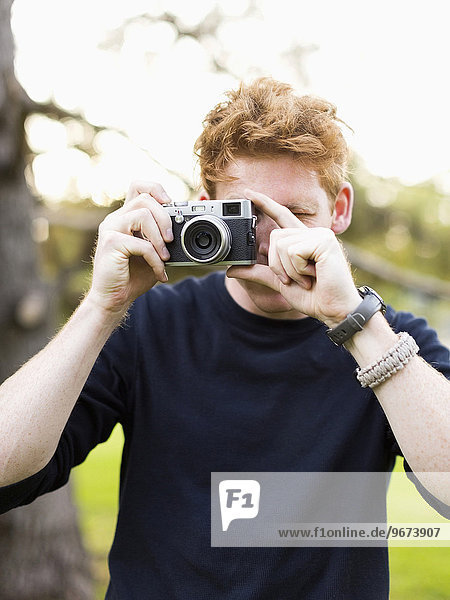 Portrait of young man taking photos
