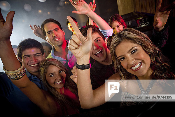 Hispanic friends dancing in nightclub