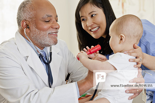 Doctor examining baby boy