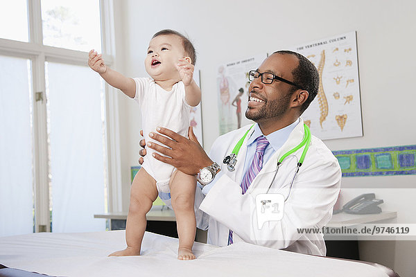 Doctor examining baby in doctor's office