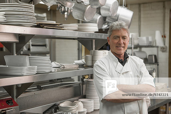 Caucasian chef standing in commercial kitchen