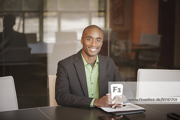 Black businessman smiling at desk