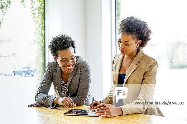 Businesswomen using digital tablet in office