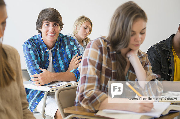Teenage student smiling in classroom