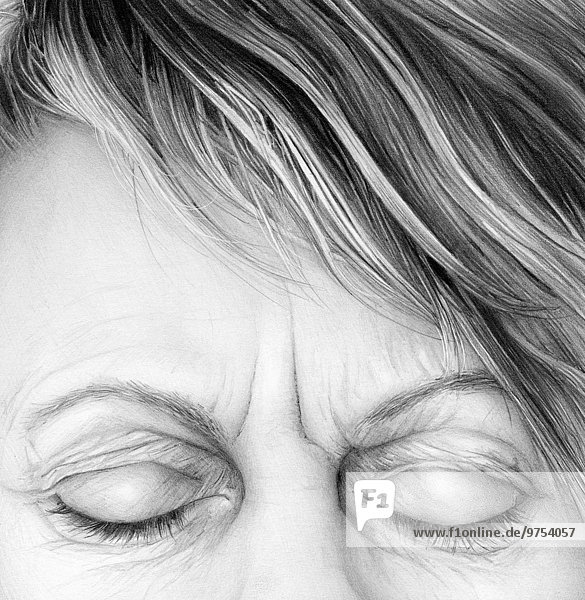 Close up of pencil drawing of woman frowning with eyes closed