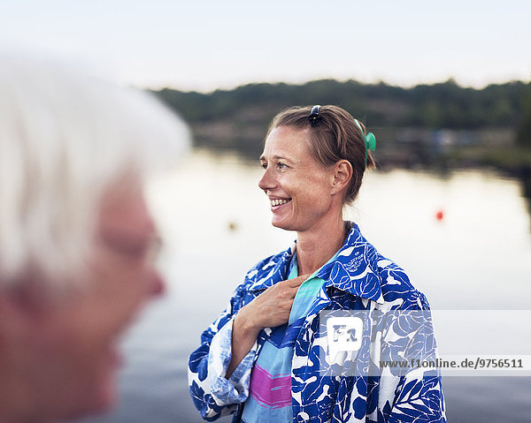 Smiling mid adult woman at water