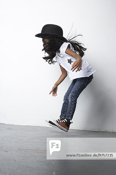 Jumping girl wearing bowler hat