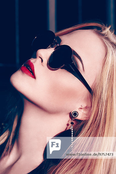 Portrait of rouged blond woman wearing sunglasses