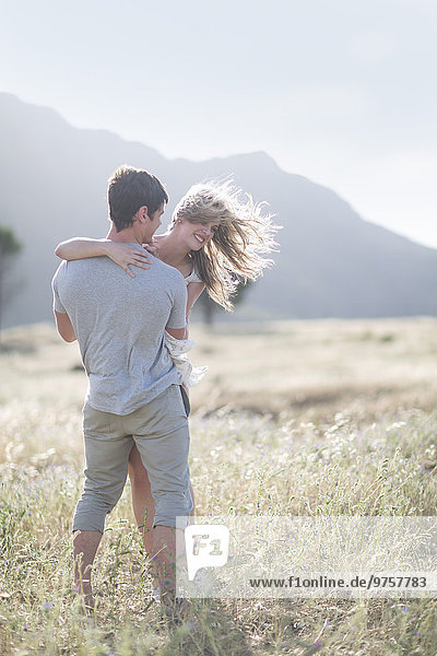 South Africa  Young couple embracing in field
