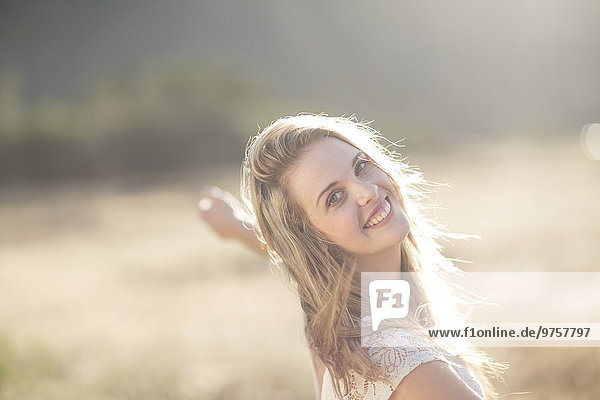 South Africa  Happy young woman dancing in field