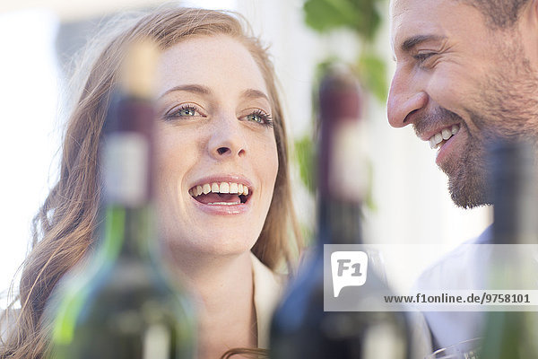 Happy couple with wine bottles outdoors